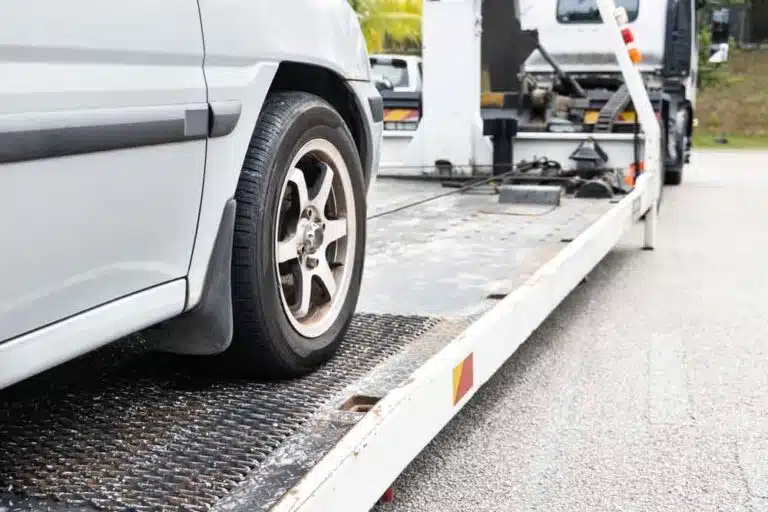 Cable Attached To A Car Being Pulled Onto Flatbed Tow Truck