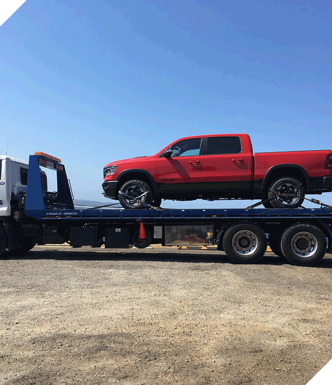 Red Car on Truck Trailer — Tow Truck Provider in the Gold Coast