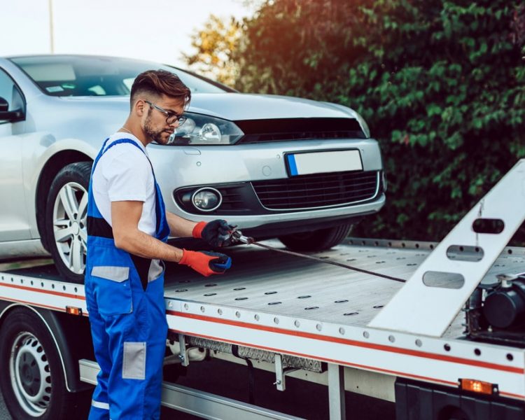 Man Towing A Vehicle