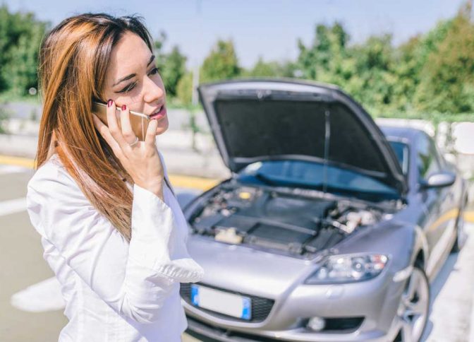 Woman Calling For Assistance Due To Car Breakdown